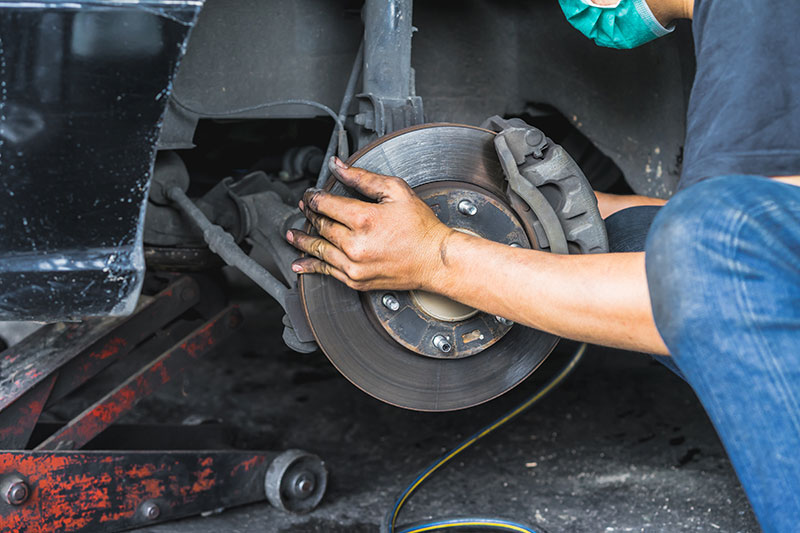 hand-car-mechanic-fixing-disc-brakes-car-maintenance-professional-service