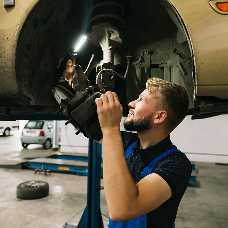 repairmen-examining-wheel-structure